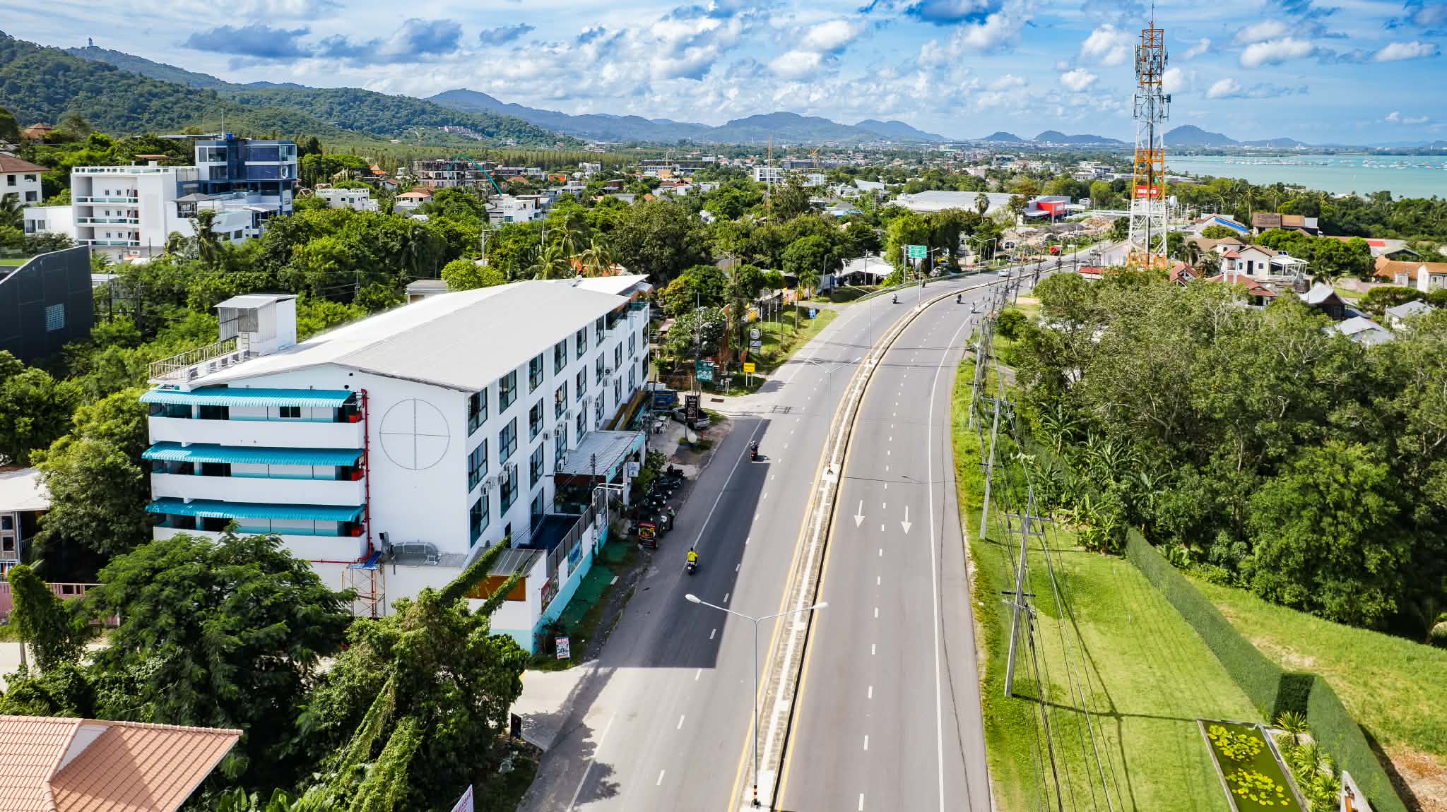 Aerial of De Blue Sea Rawai Hotel with Wiset Road running toward the sea