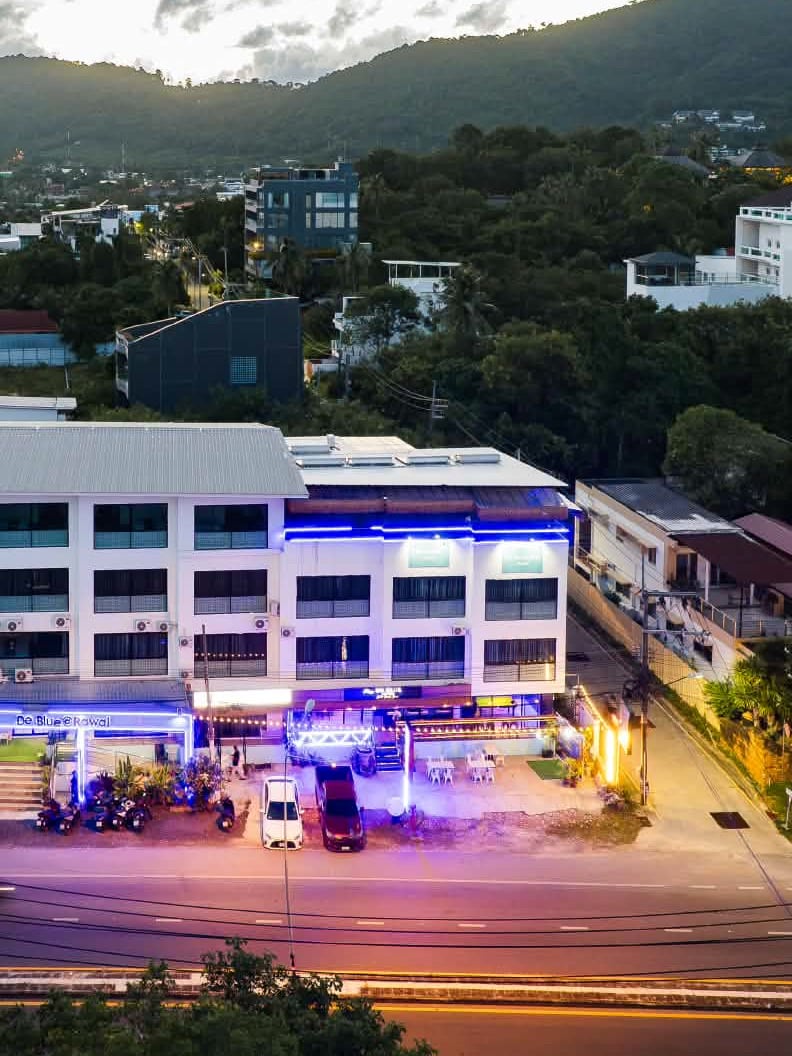De Blue Sea Rawai Hotel front at dusk with the blue lights on