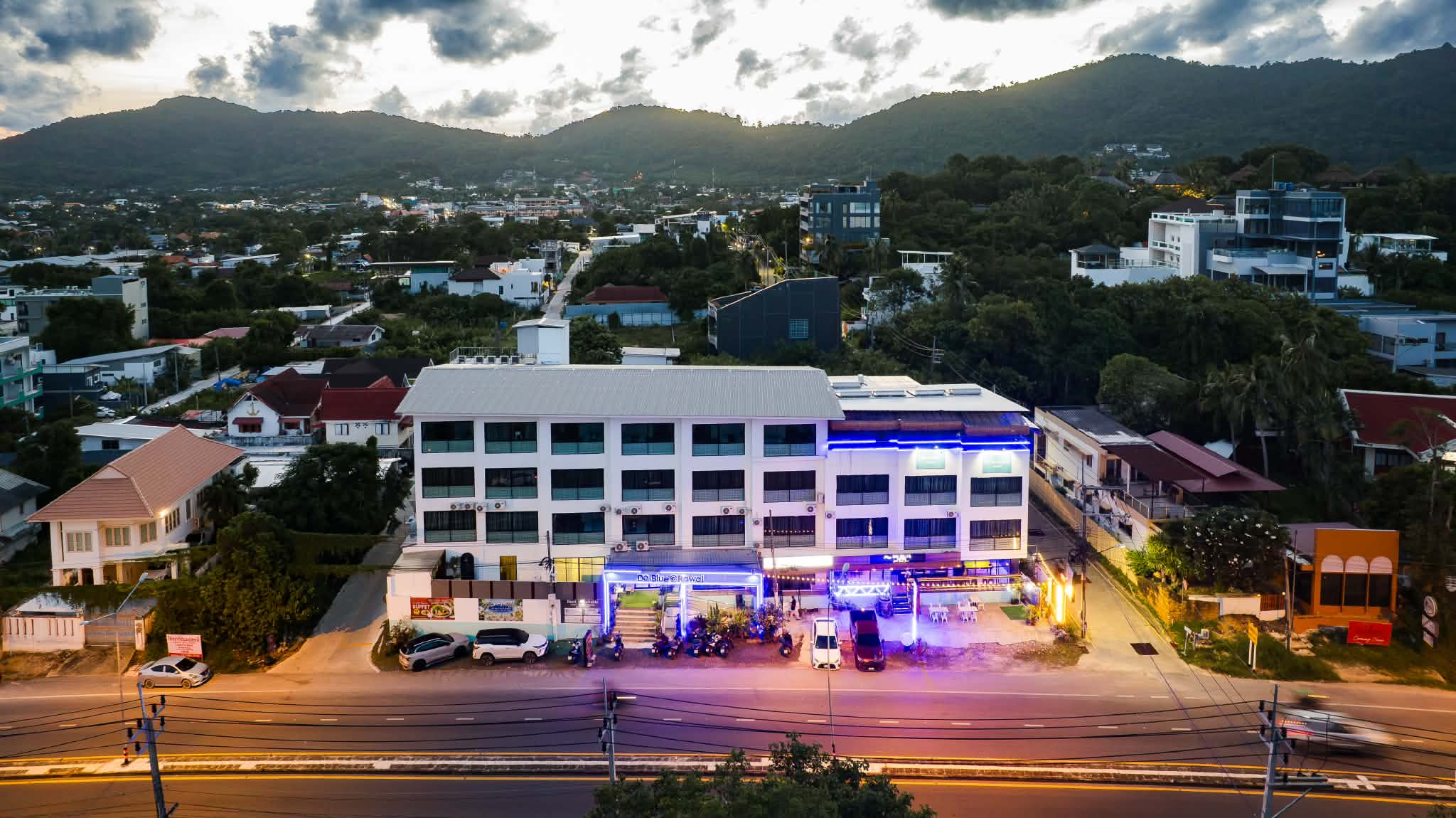 De Blue Sea Rawai Hotel front at dusk with the blue lights on